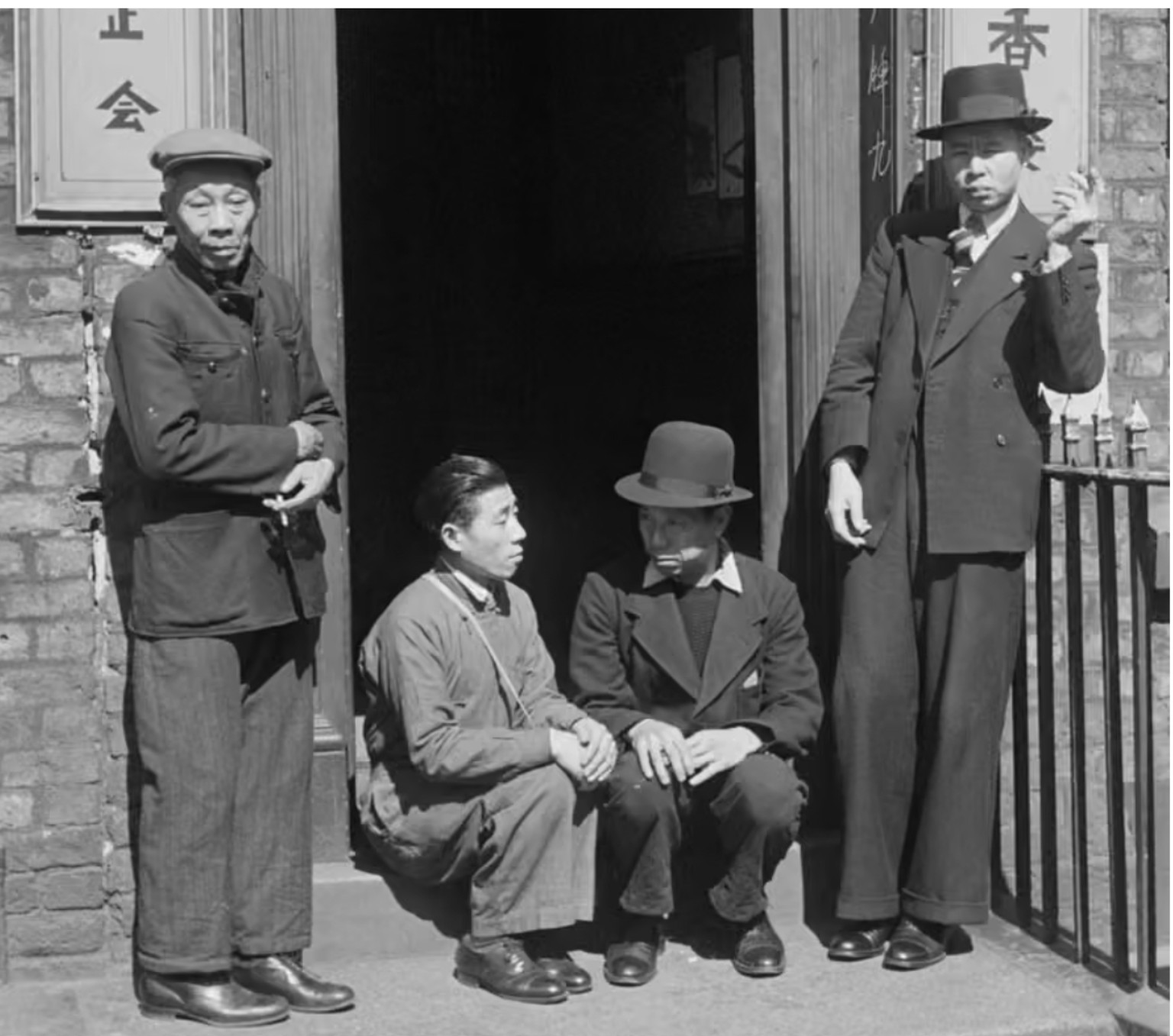 Four Chinese merchant seamen outside a Liverpool hostel during the Second World War.