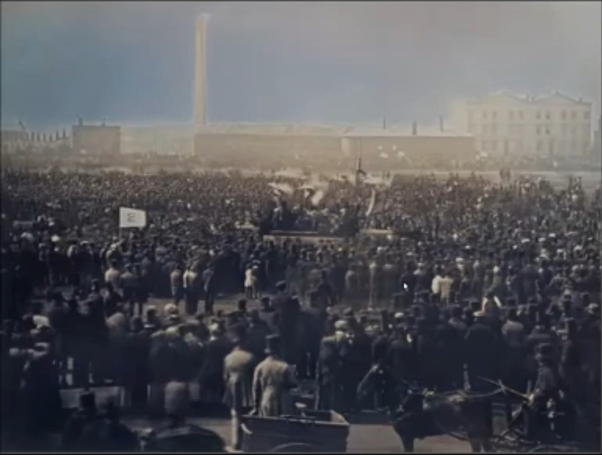 Historical image of a large nineteenth-century outdoor crowd gathered around a raised platform.
