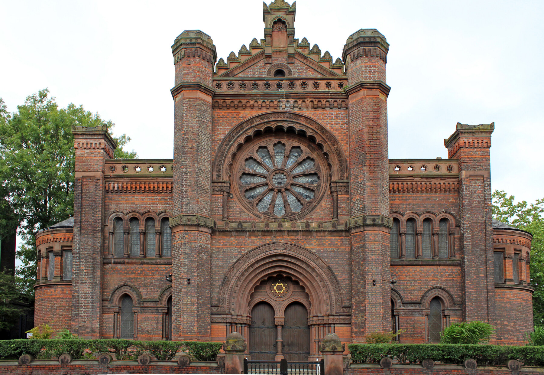Front elevation of Princes Road Synagogue in Toxteth, showing its red-brick façade, towers and large rose window.